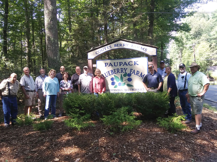 Wayne-Pike pose in front of the Paupack Blueberry Farm sign