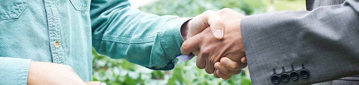 farmer and businessman shaking hands